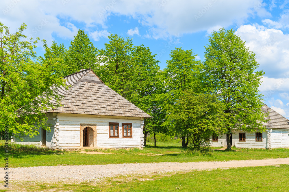 Old traditional houses with straw roofs in Tokarnia village on sunny spring day, Poland Old traditional houses with straw roofs in Tokarnia village on sunny spring day, Poland