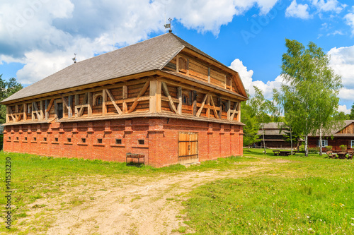 Old traditional mill building in Tokarnia village on sunny spring day, Poland