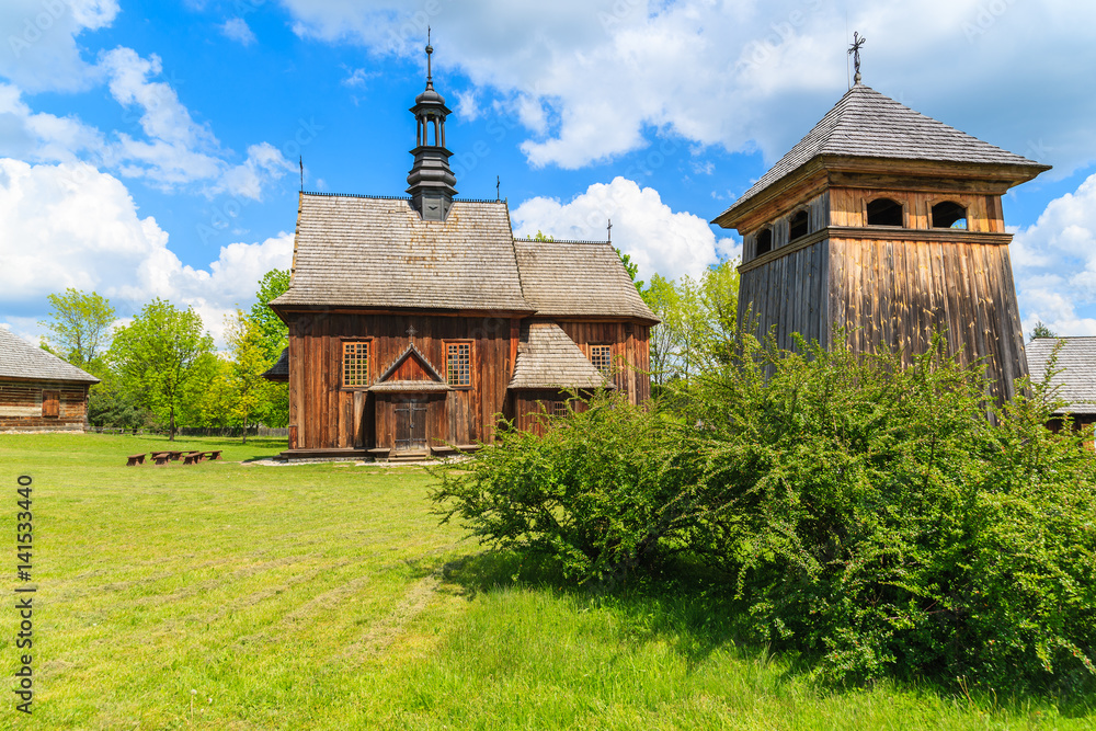 Traditional wooden church in Tokarnia village on sunny spring day, Poland