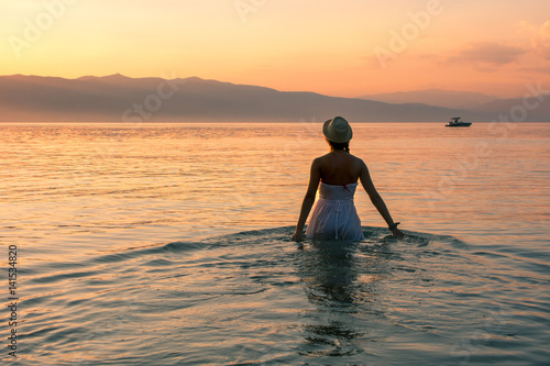 Walk towards sunset in the lake