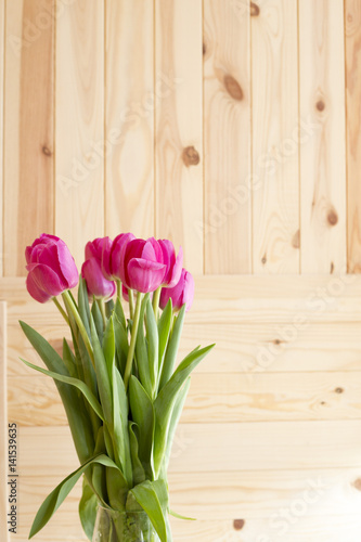 Bouquet of pink tulips on a wooden background 