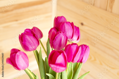 Fototapeta Naklejka Na Ścianę i Meble -  Bouquet of pink tulips on a wooden background
