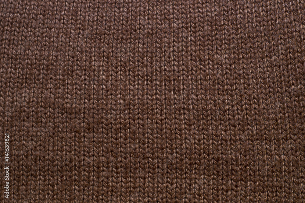 Fototapeta premium Knitted brown background. Fabric texture