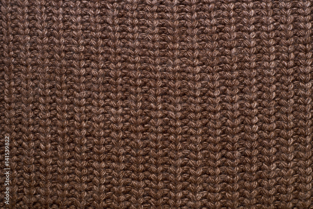 Knitted brown background. Fabric texture Knitted brown background. Fabric texture