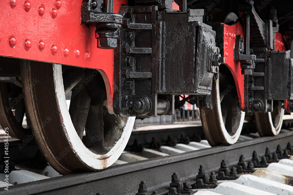 The wheels of locomotives on the railroad. Closeup.