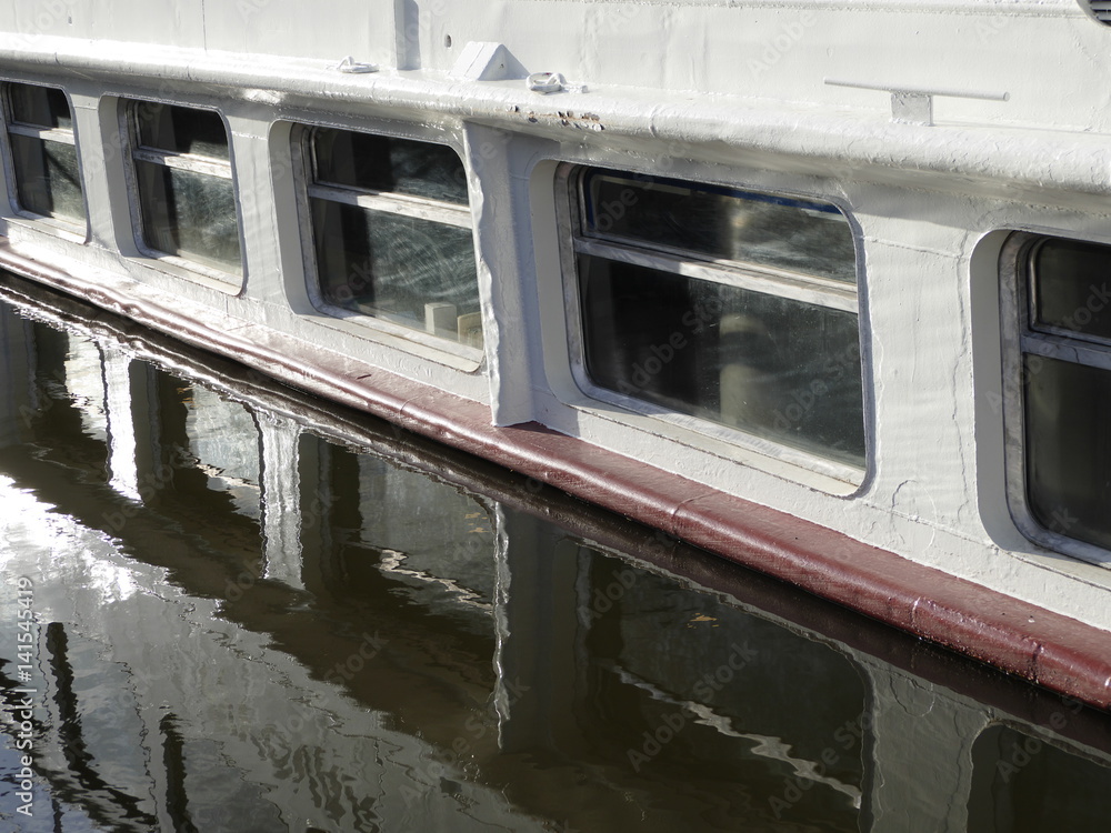 boat windows reflected in a water level