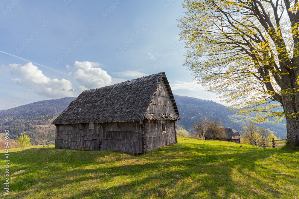 Old wooden house in the background of the mountains. Carpathians Old wooden house in the background of the mountains. Carpathians