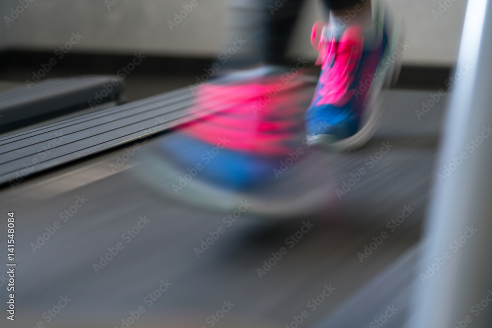 Obraz premium Woman running on treadmill