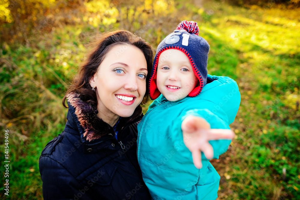 Mother with son in autumn peach garden Mother with son in autumn peach garden