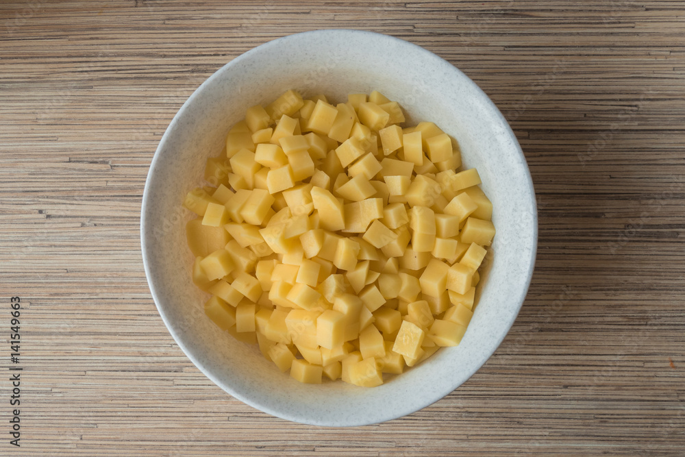 Raw potatoes diced / Sliced potatoes in white plate Raw potatoes diced / Sliced potatoes in white plate