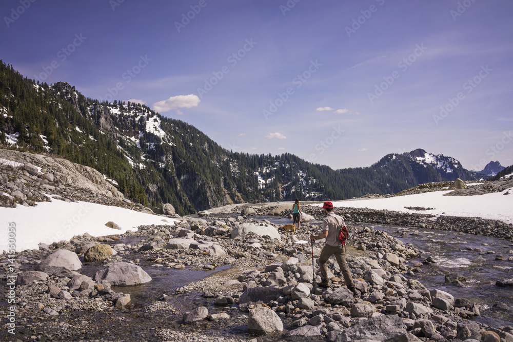 Couple hiking in mountains with dog, Couple hiking in mountains with dog,