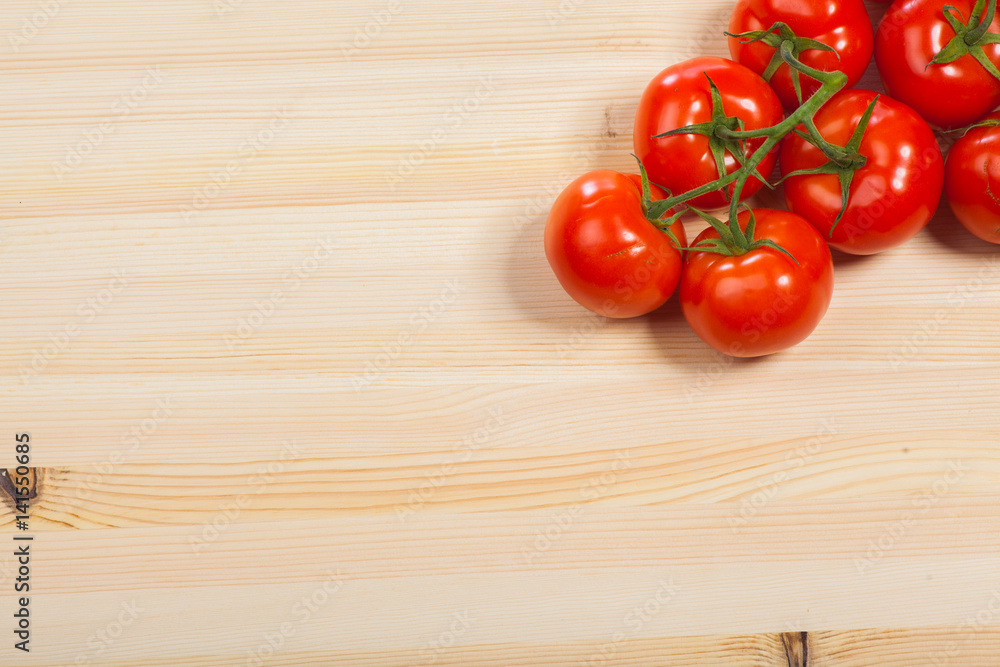 Fresh red tomatoes on the wood table, isolated Fresh red tomatoes on the wood table, isolated