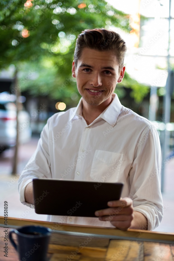 Man using digital tablet at counter