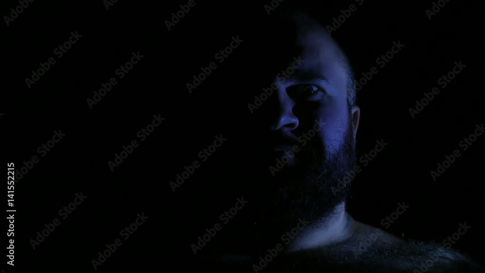 Mad insane crazy evil man laughing in darkness closeup. 4K UHD Mad insane crazy evil man laughing in darkness closeup. 4K UHD