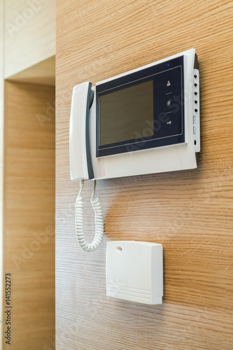 video door phone with a screen on the wall of wood