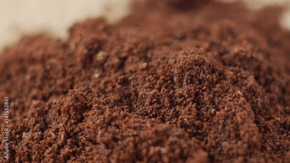 Fine ground coffee powder pile close-up shallow DOF. The slow rotation. Fine ground coffee powder pile close-up shallow DOF. The slow rotation.