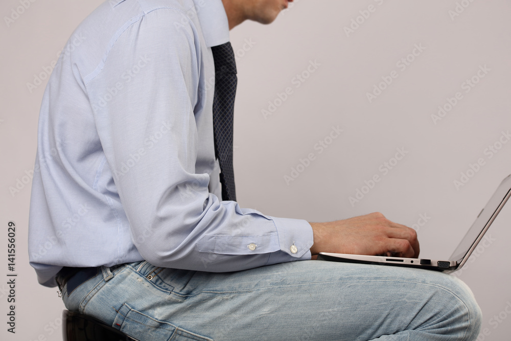 Man bad poor sitting posture. Business man using laptop computer Man bad poor sitting posture. Business man using laptop computer