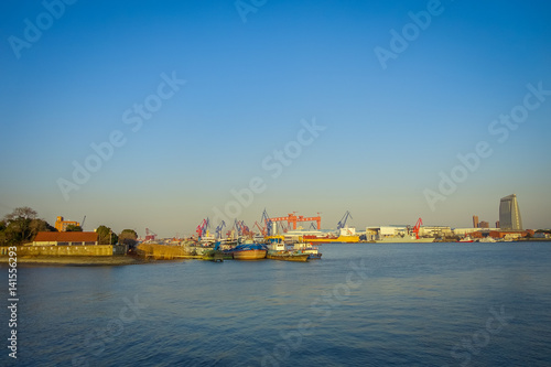 SHANGHAI, CHINA: Shanghai riverbank, industrial boats and some port facilities lying waterfront, beautiful blue sky © Fotos 593