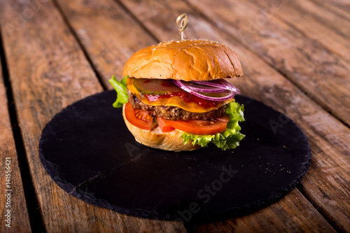 beef Burger with cheese and bacon on wooden background