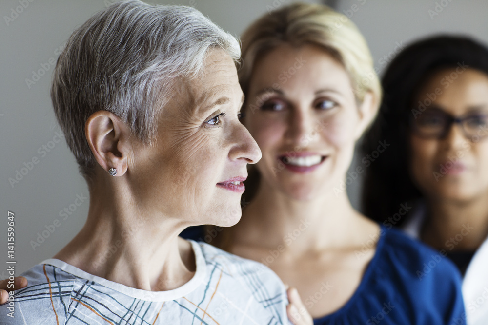 Smiling woman in hospital gown, Smiling woman in hospital gown,