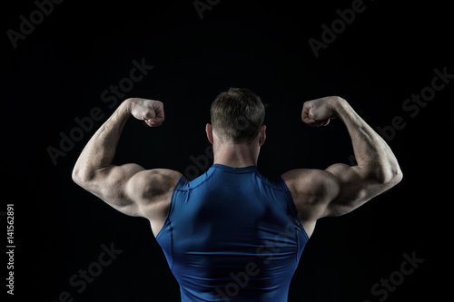 handsome bodybuilder man with muscular body training in gym
