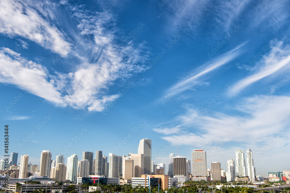 Fototapeta premium buildings, skyscrapers, hotels and urban houses on cloudy blue sky