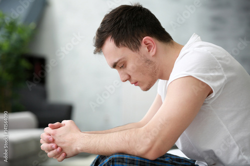 Handsome depressed man at home
