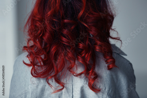 Billede på lærred Beautiful young woman with dyed curly hair indoors, closeup