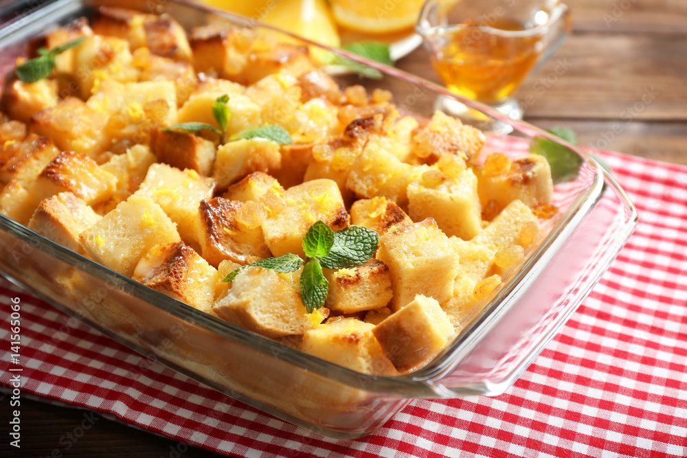 Delicious bread pudding with raisins in glass dish Delicious bread pudding with raisins in glass dish
