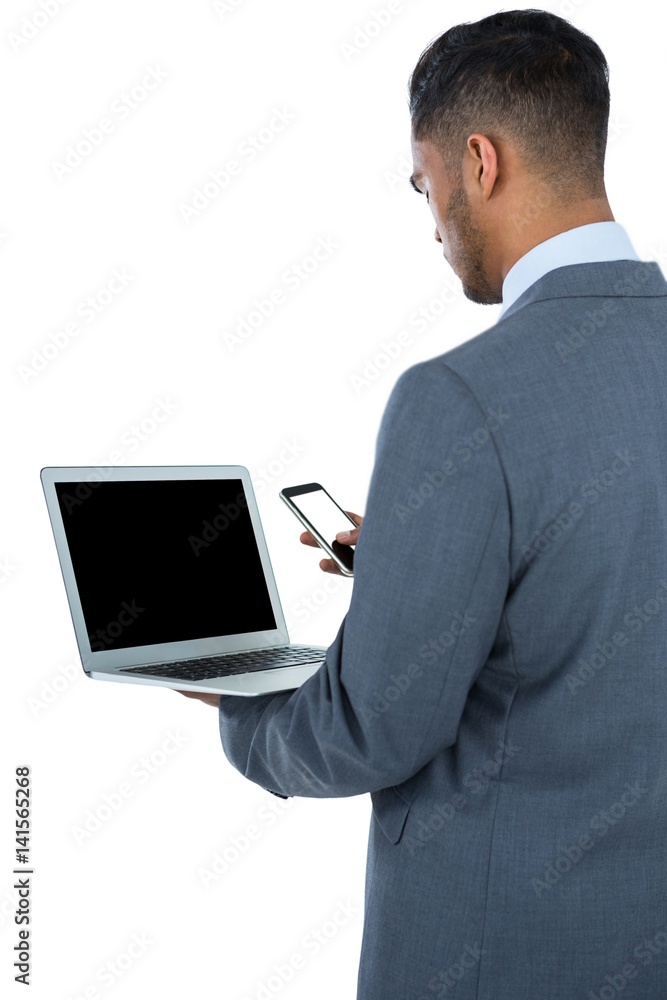 Businessman using laptop and mobile phone Businessman using laptop and mobile phone