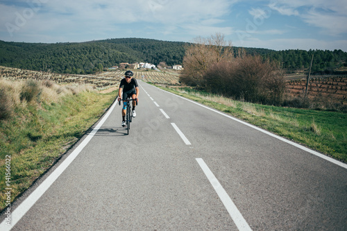 Fototapeta Naklejka Na Ścianę i Meble -  Male professional cyclist climbing in the Spanish mountains
