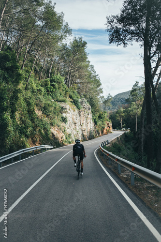Male professional cyclist climbing in the Spanish mountains