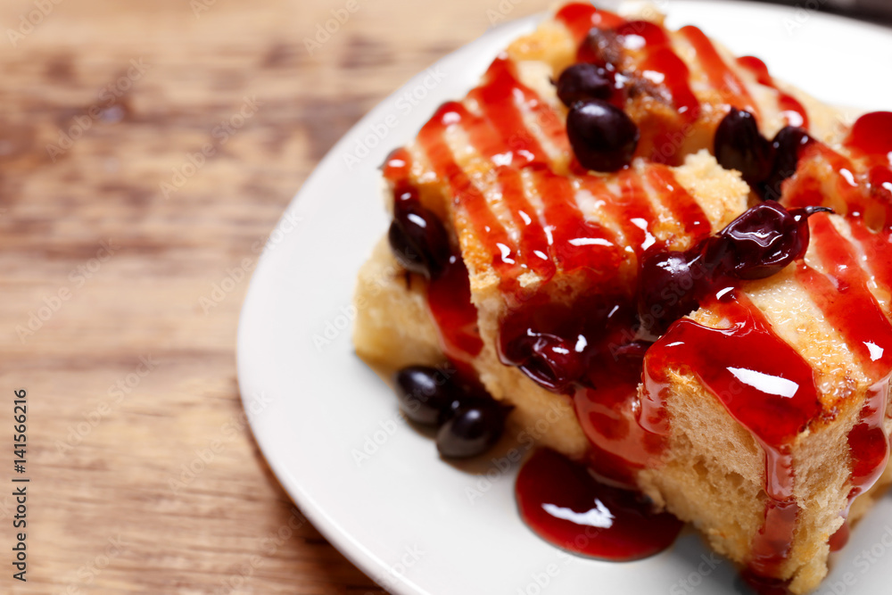 Delicious bread pudding with currant and jam on plate Delicious bread pudding with currant and jam on plate