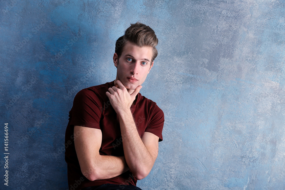 Handsome young man on color background