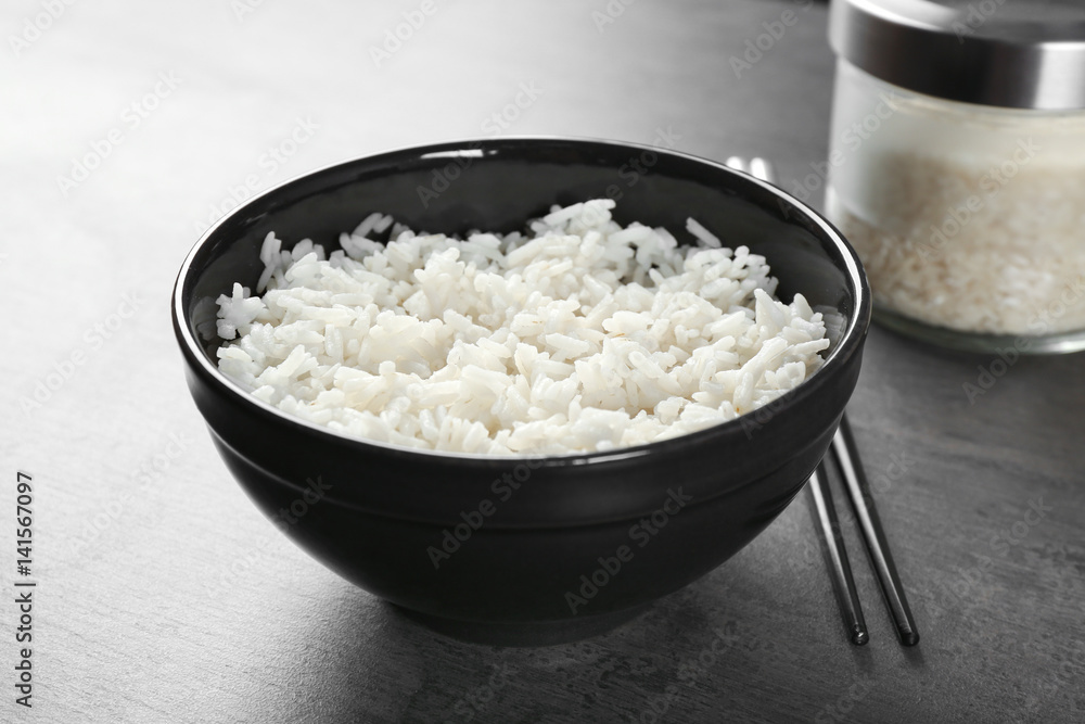 Bowl of rice and chopsticks on color background Stock Photo | Adobe Stock