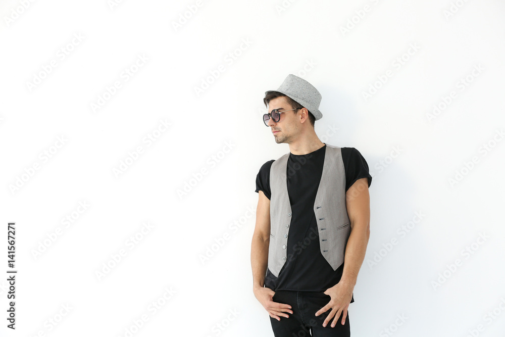 Handsome stylish young man posing on light background Handsome stylish young man posing on light background