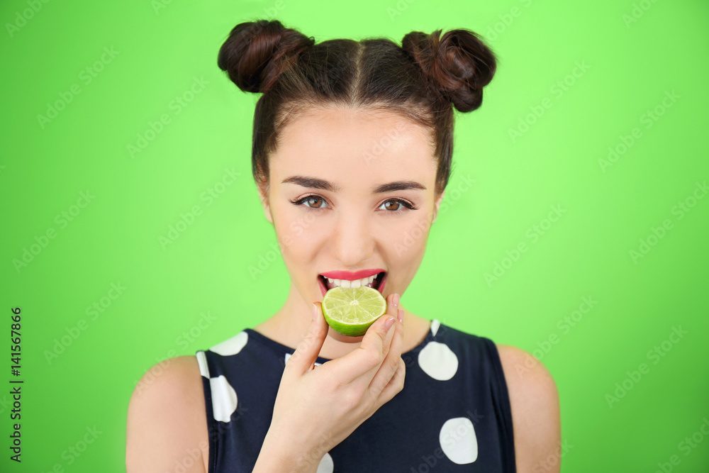 Beautiful young woman with lime on color background Beautiful young woman with lime on color background