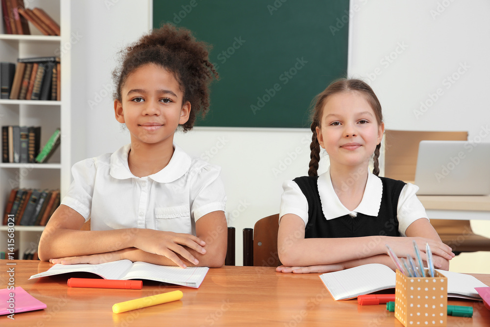 Beautiful elementary schoolgirls studying in classroom Beautiful elementary schoolgirls studying in classroom