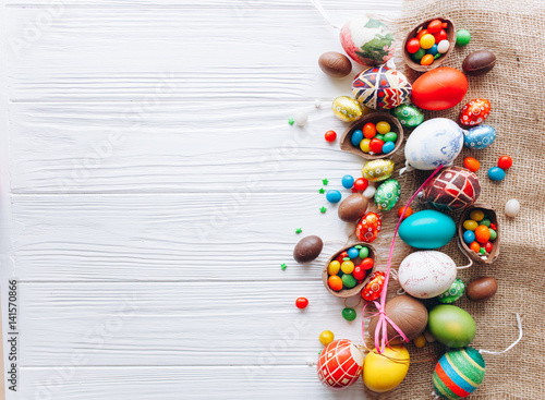  colored easter eggs and  on white wooden background