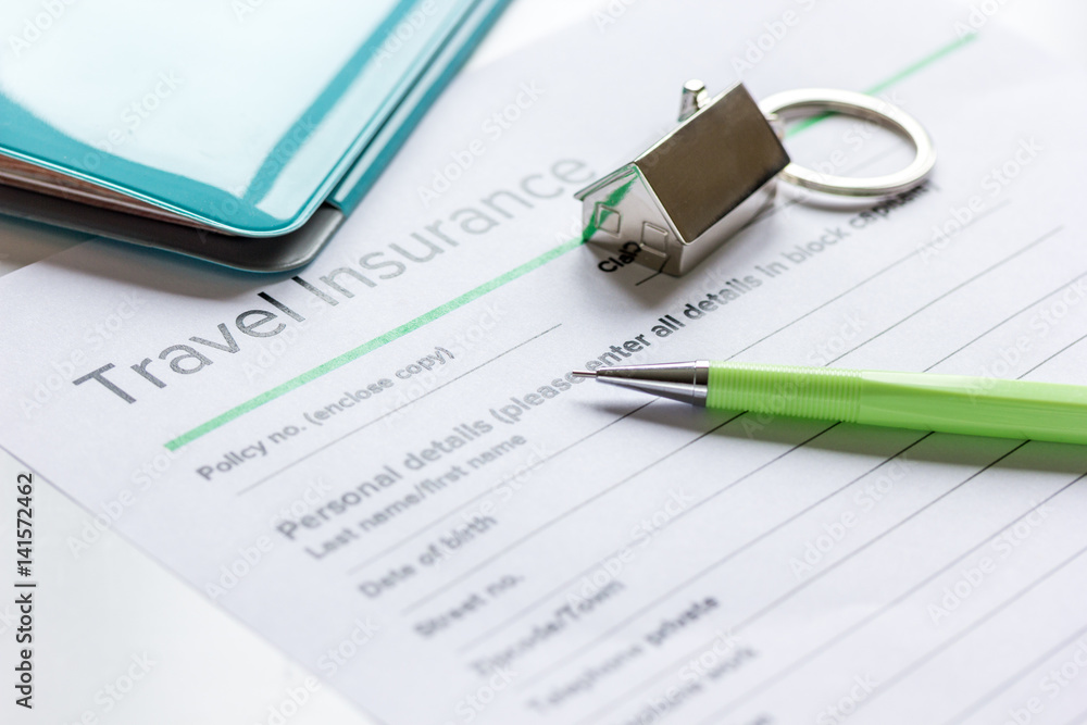 Traveling concept with insurance application on white table Traveling concept with insurance application on white table