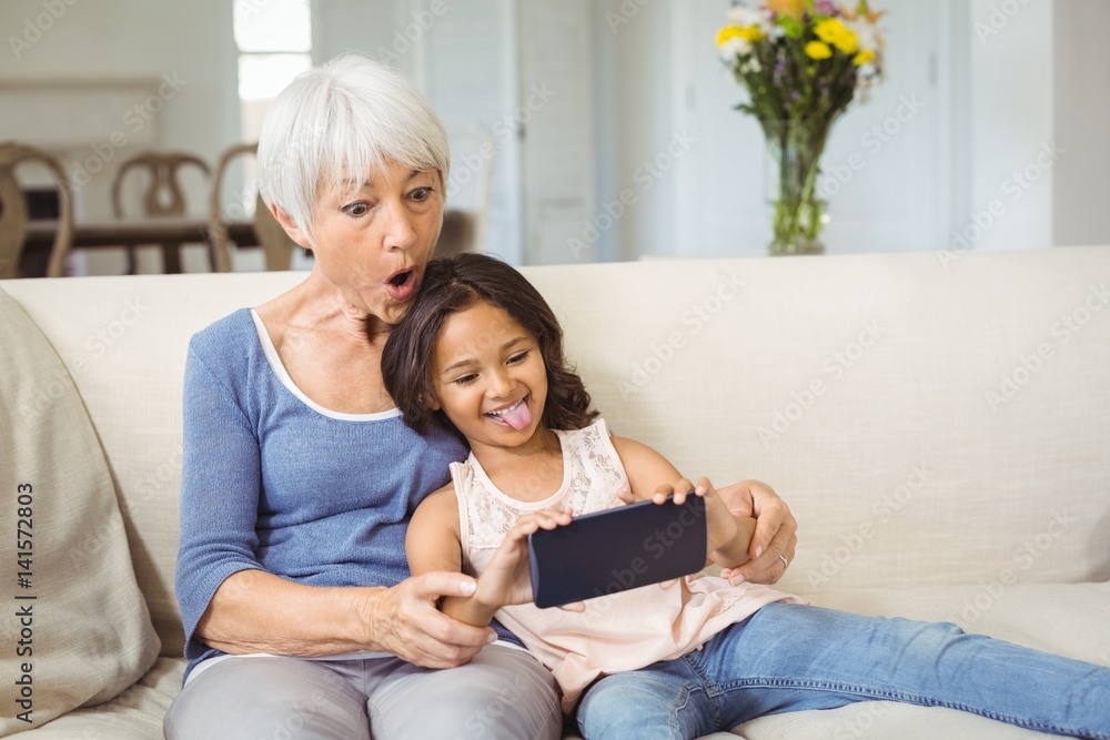 Granddaughter and grandmother taking selfie Granddaughter and grandmother taking selfie