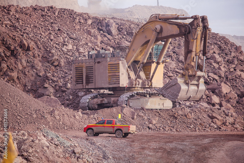 Big shovel loading of copper ore near to pickup truck