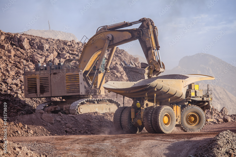 Fototapeta premium Loading of copper ore on very big dump-body truck