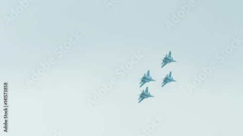 An su-35 Fighter Jet flying high above the clouds. Russian fighter flies a dangerous maneuver