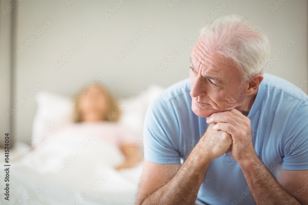 Worried senior man sitting in bedroom Worried senior man sitting in bedroom
