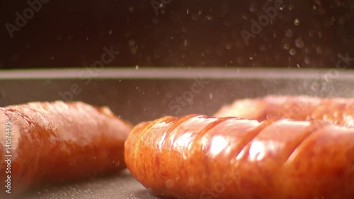 Frying sausages / slow motion shot