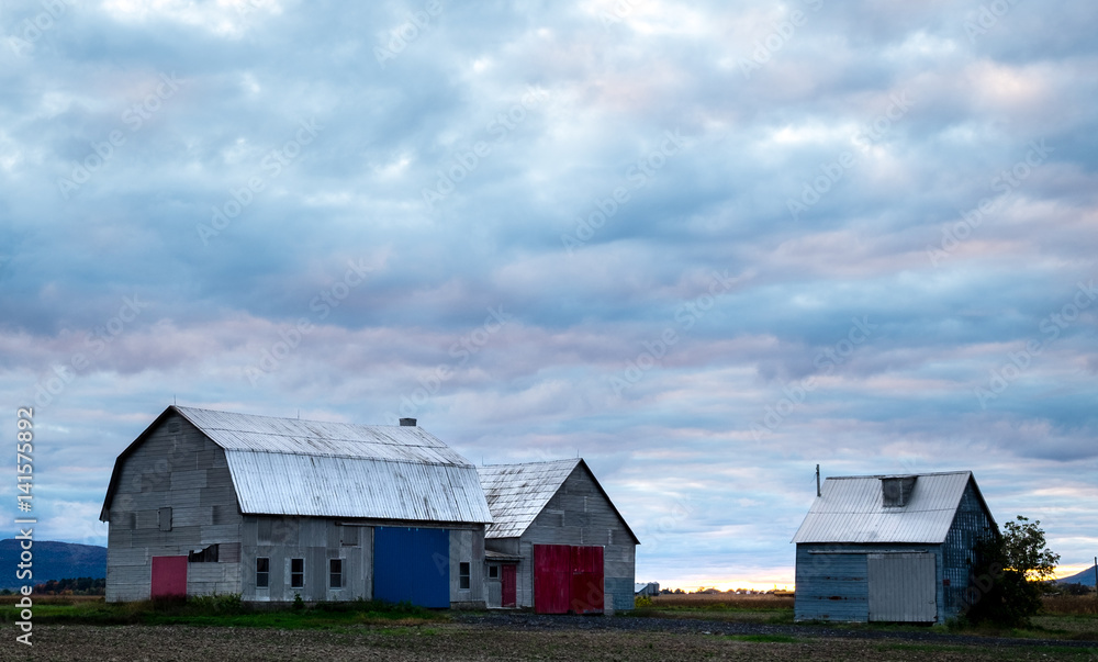 Old barn under a beautiful sky before sunset