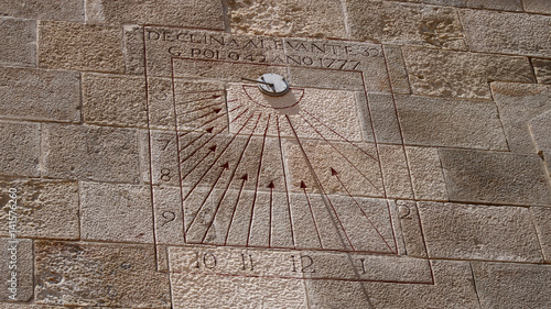 Close view of a sundial on a wall a sunny day at fort Montjuic in Barcelona, Spain