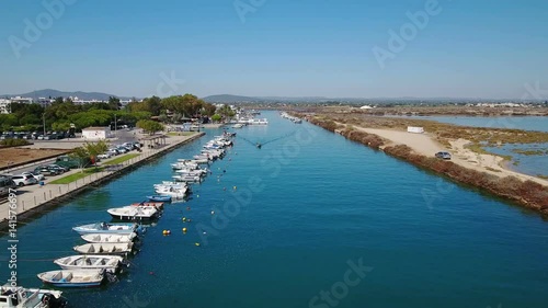 Aerial. The boat is sailing to sea on the Ria Formosa. Fusetta Tavira.