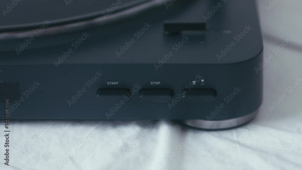 CU female hand turning on modern vinyl turntable player. 4K UHD RAW edited footage CU female hand turning on modern vinyl turntable player. 4K UHD RAW edited footage